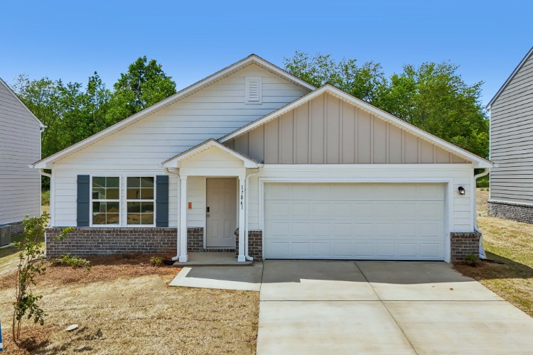 A house with a garage with American Gothic House in the background.