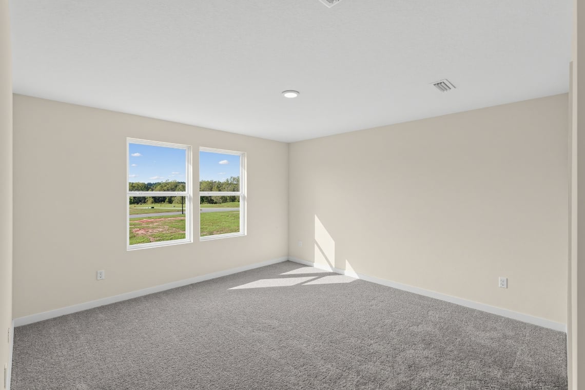 A room with a window and a carpet.