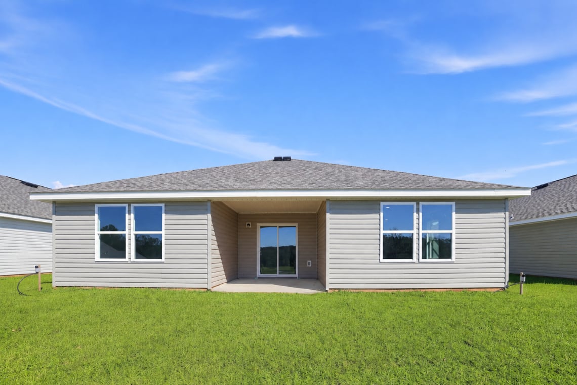 A house with a lawn in front of it.