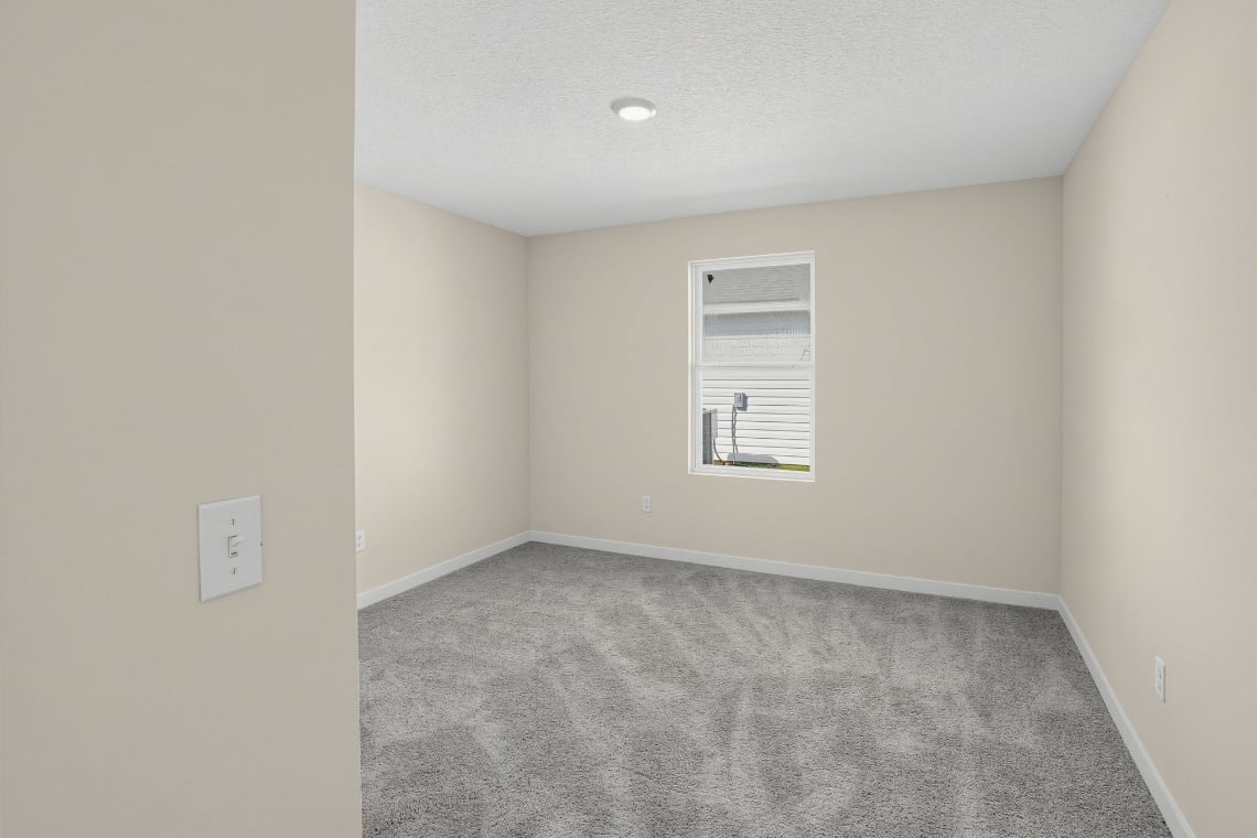 A hallway with a carpet.