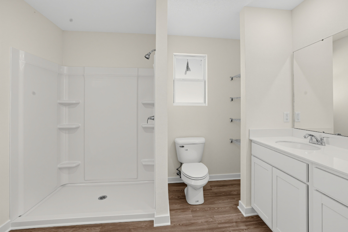 A bathroom with white cabinets.