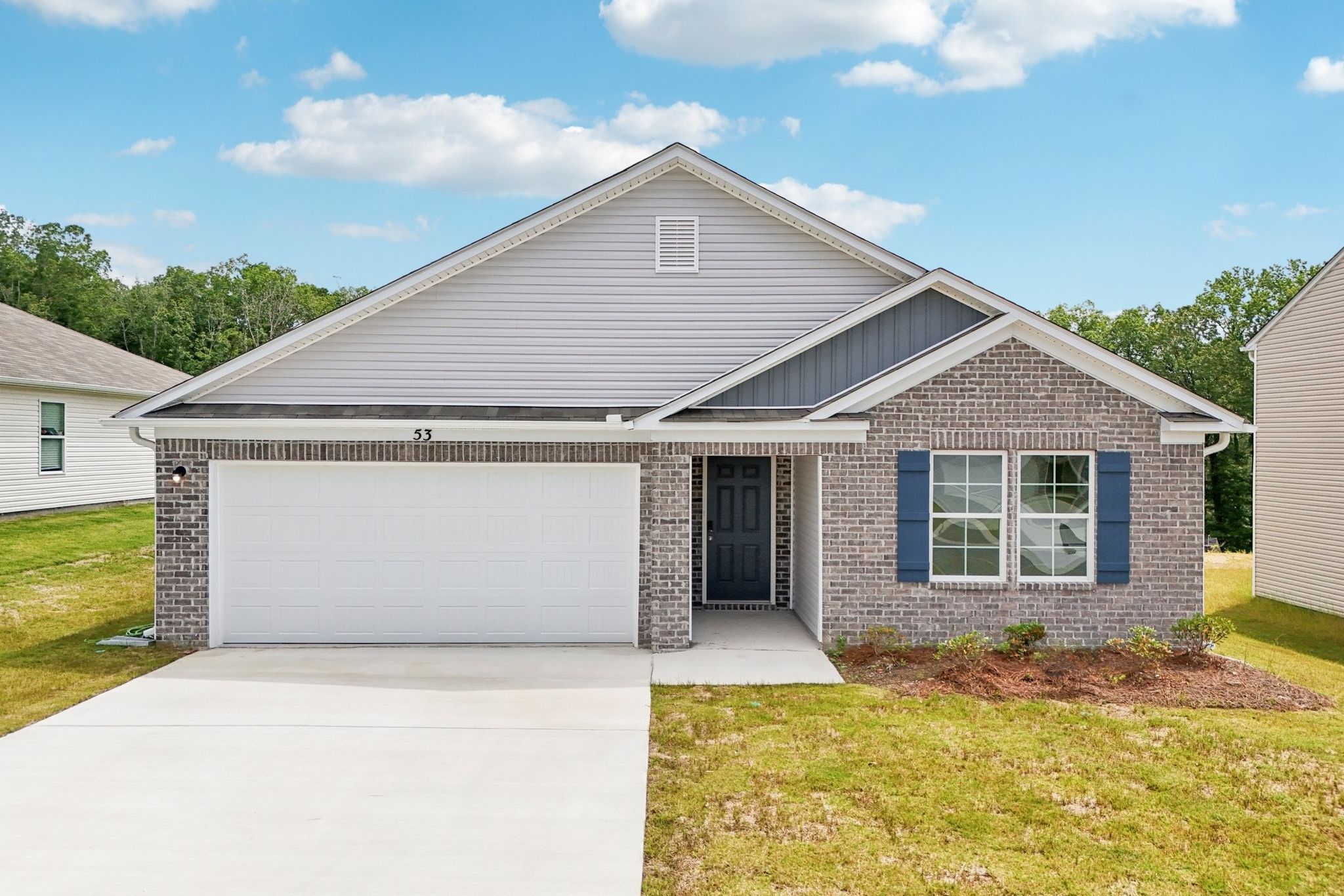 A house with a garage with American Gothic House in the background.