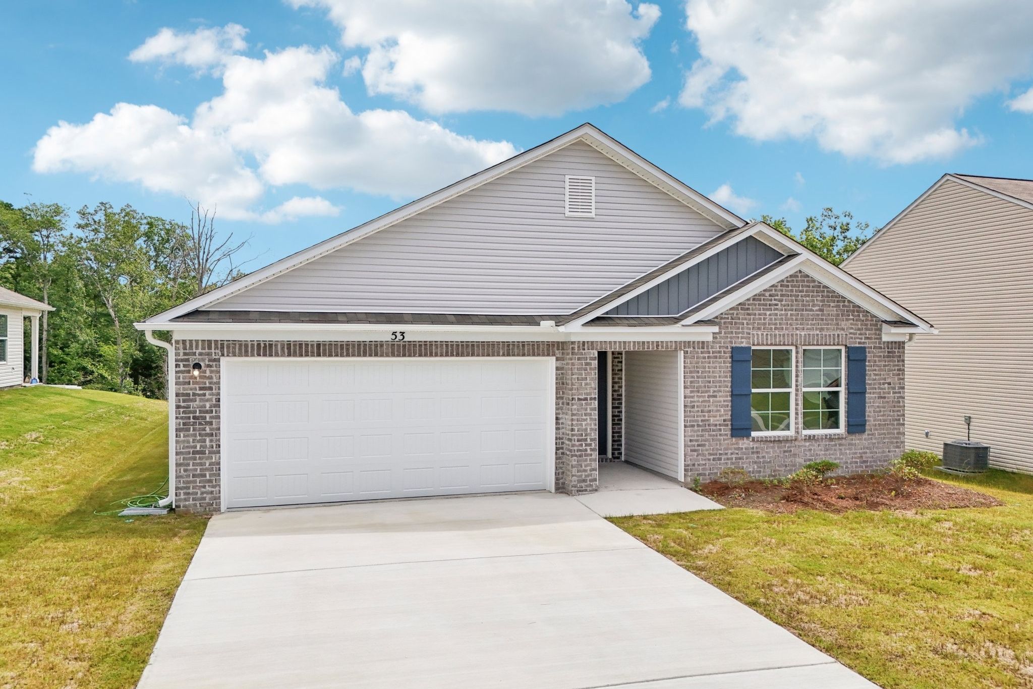 A house with a garage with American Gothic House in the background.