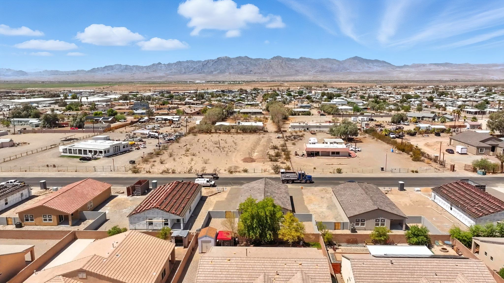 A large area with many buildings and a mountain in the background.
