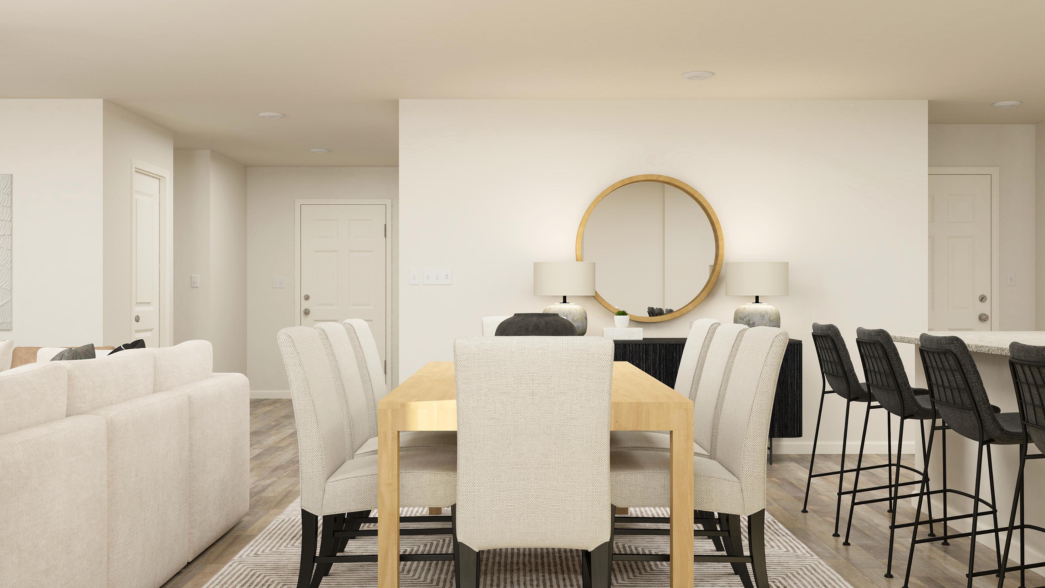 A room with a table chairs and a mirror.