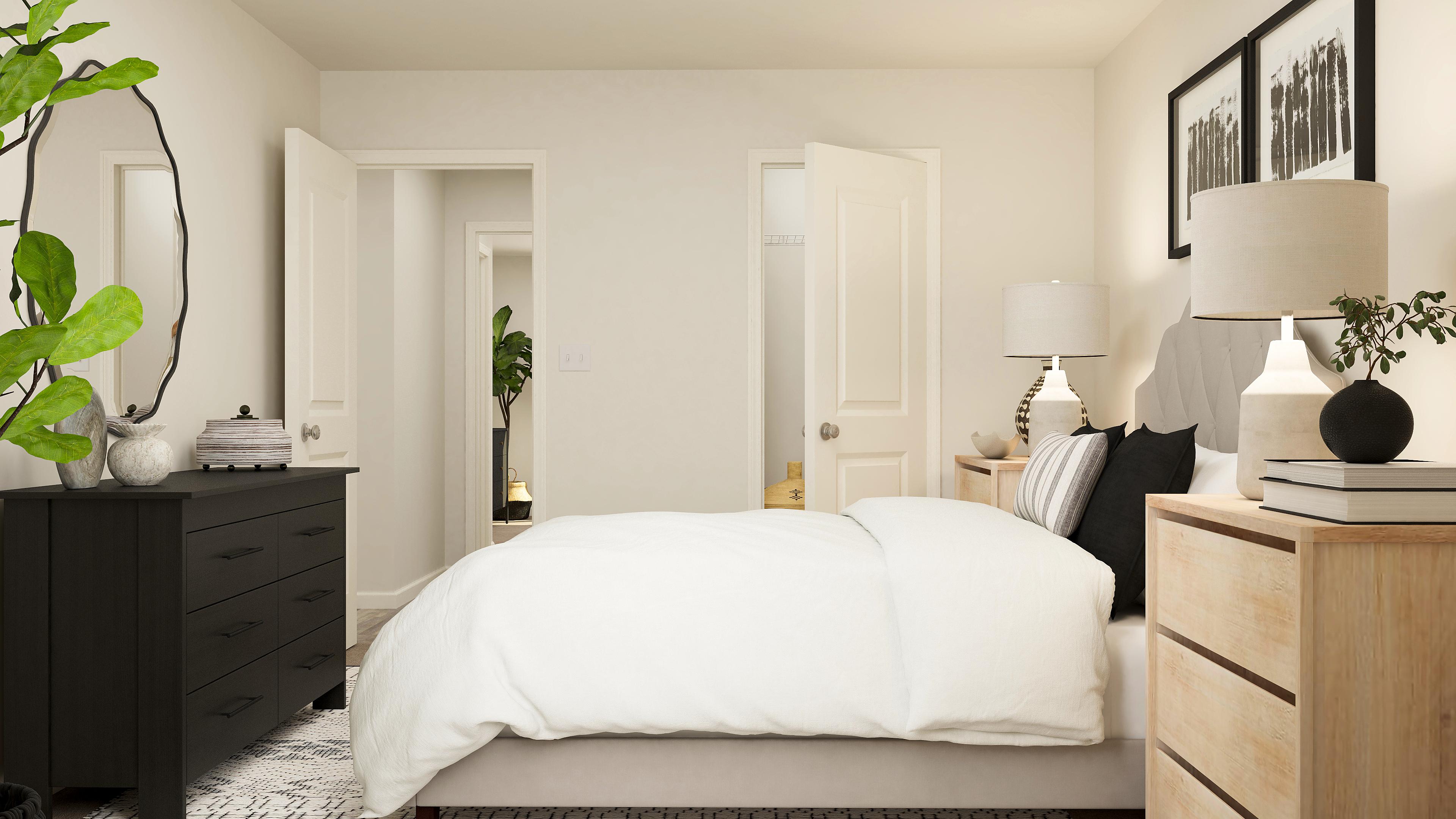 A bedroom with a bed and lamps.