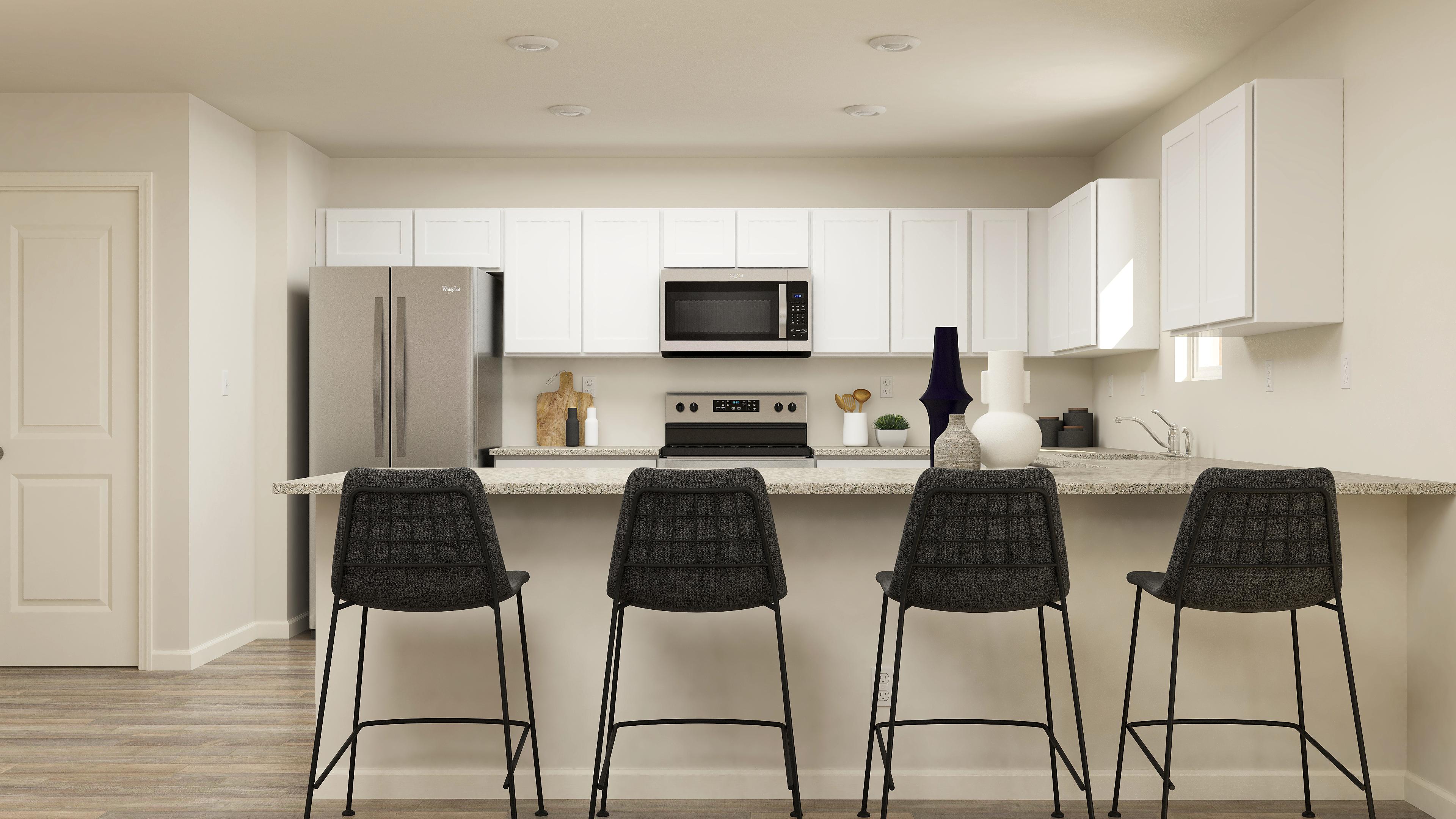 Kitchen with white cabinets and granite countertops.
