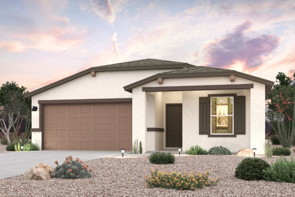 A house with a garage and bushes.