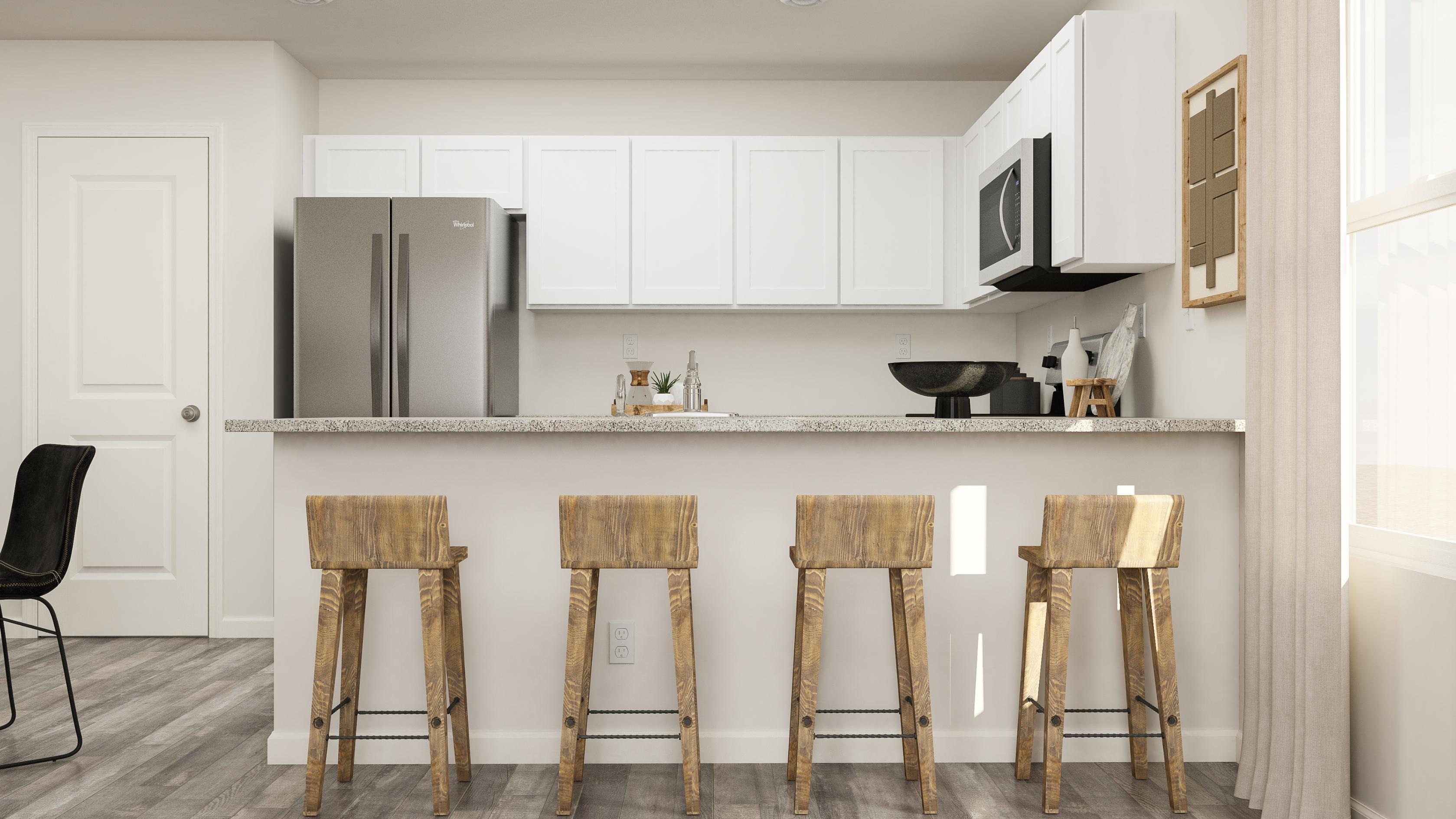 A kitchen with stools and a table.