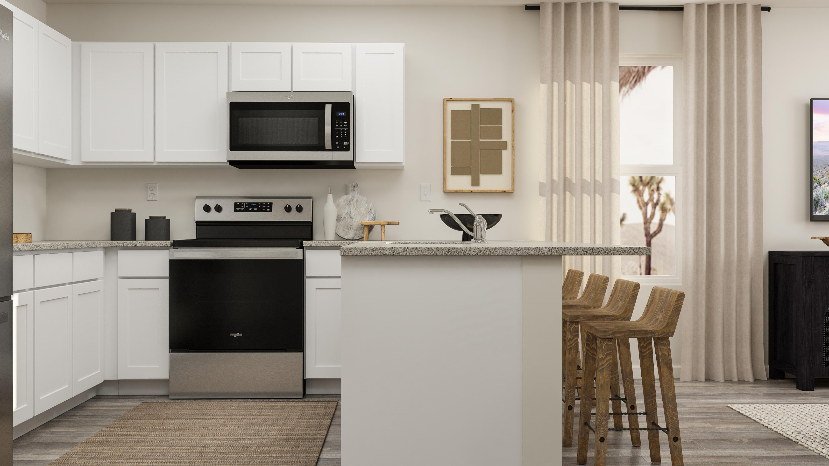 A kitchen with white cabinets.