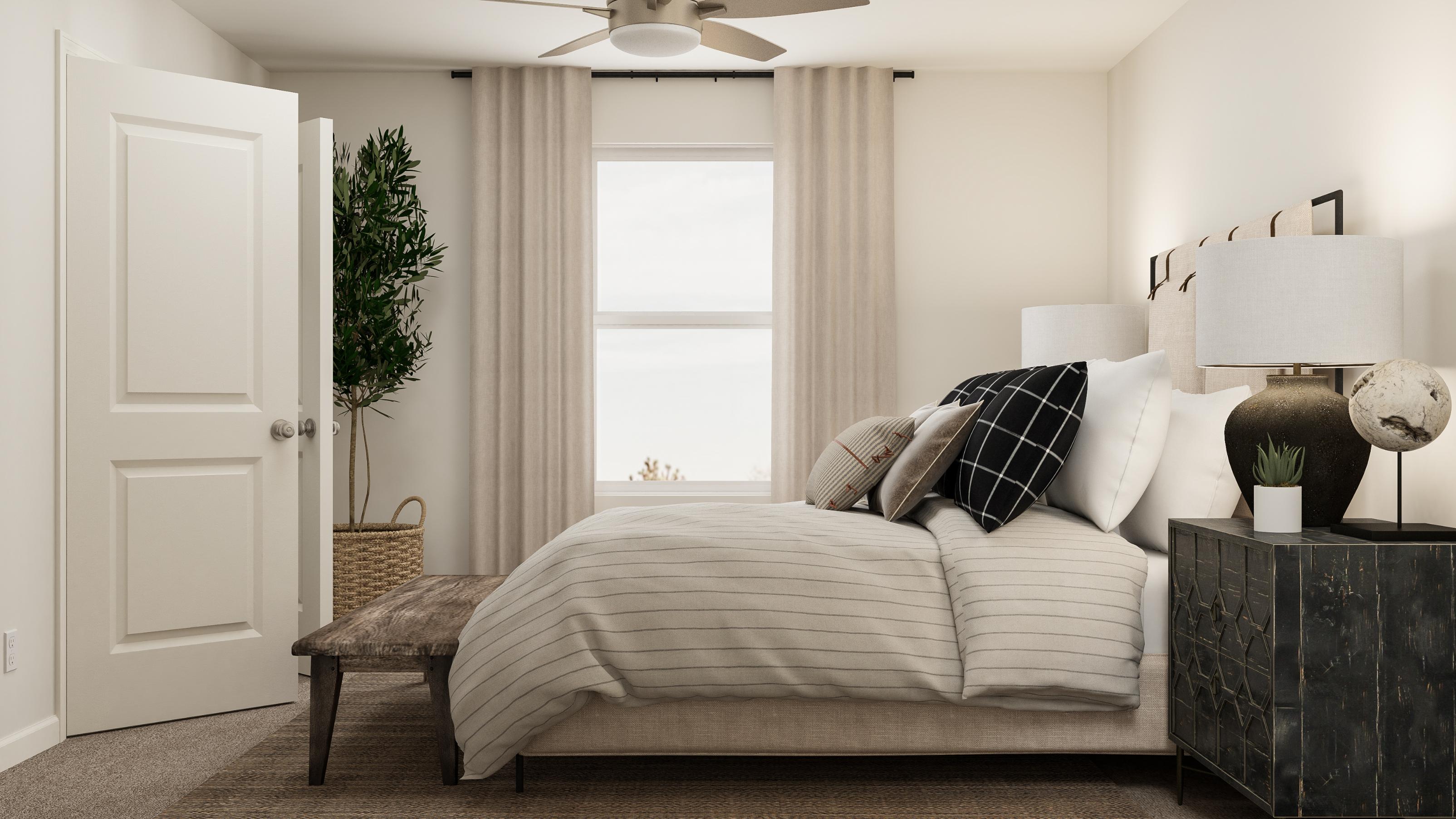 A bedroom with a bed and a table.