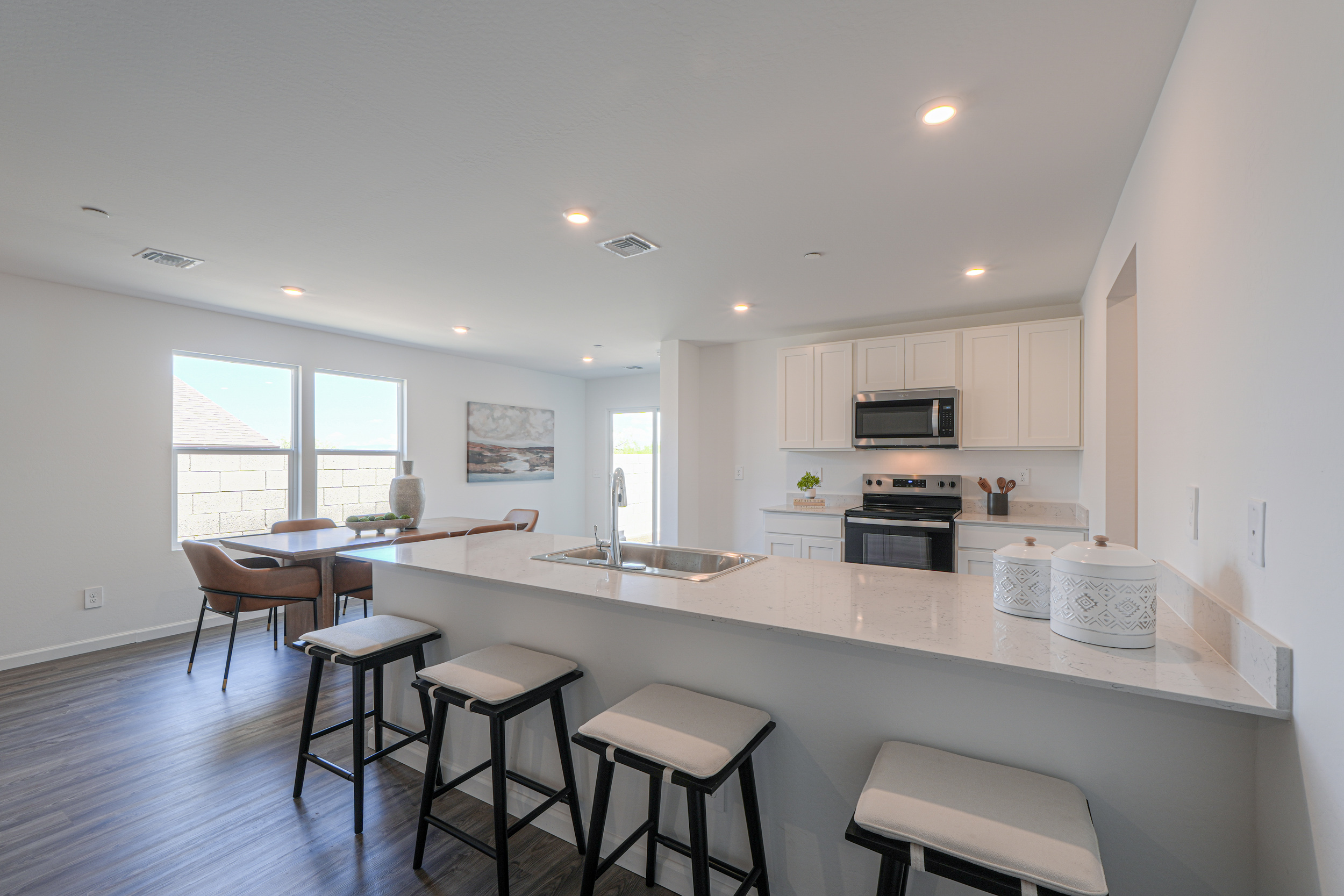A kitchen with a bar and stools.