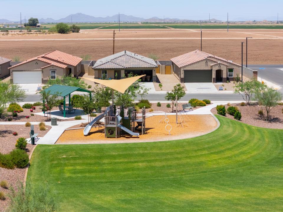 A golf course with a few buildings.