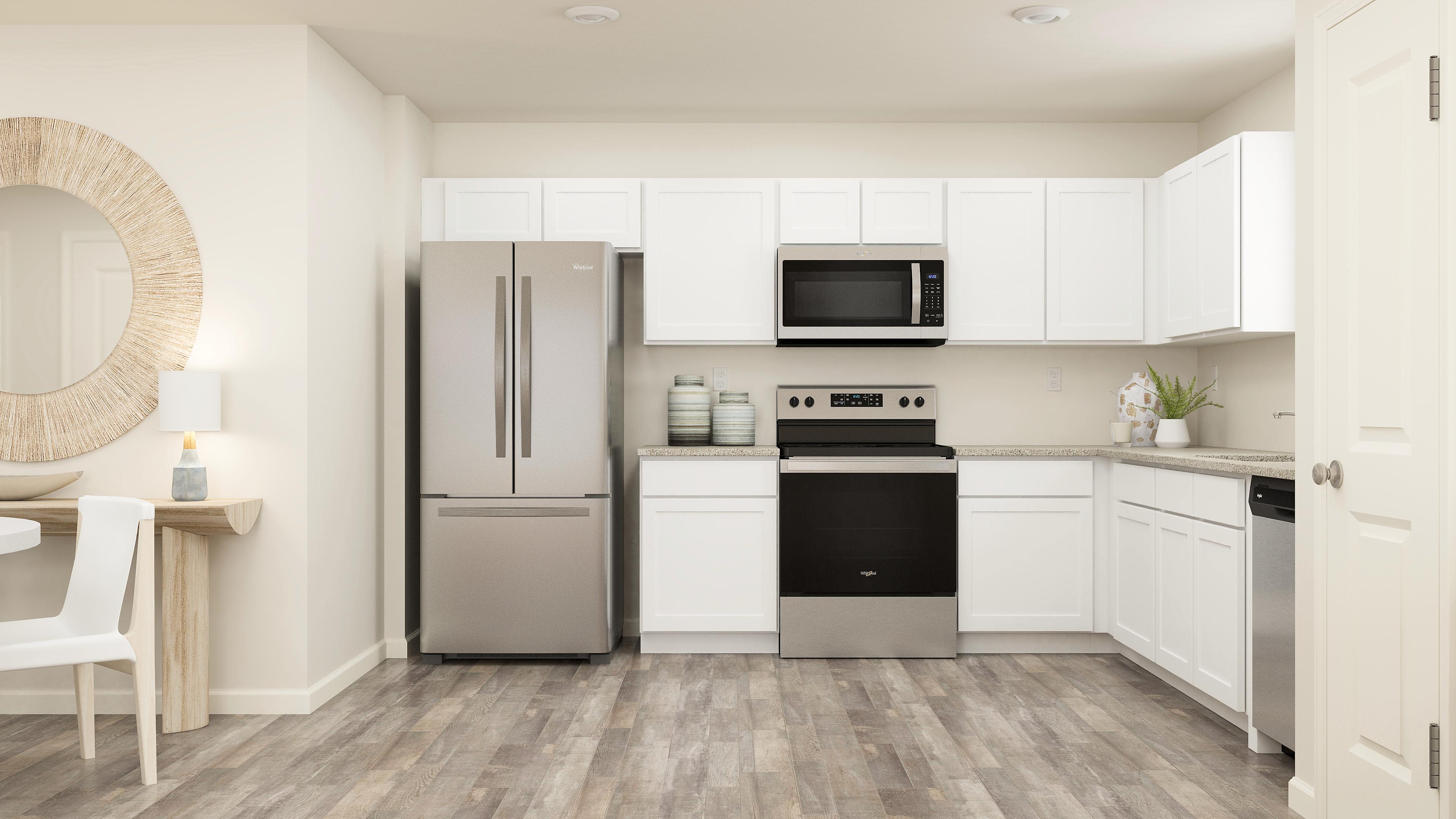 A kitchen with white cabinets.