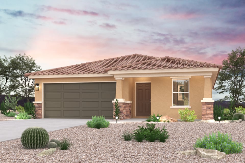 A house with a garage and bushes.