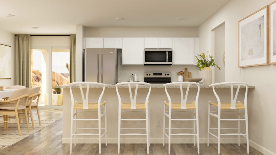 A kitchen with white chairs.
