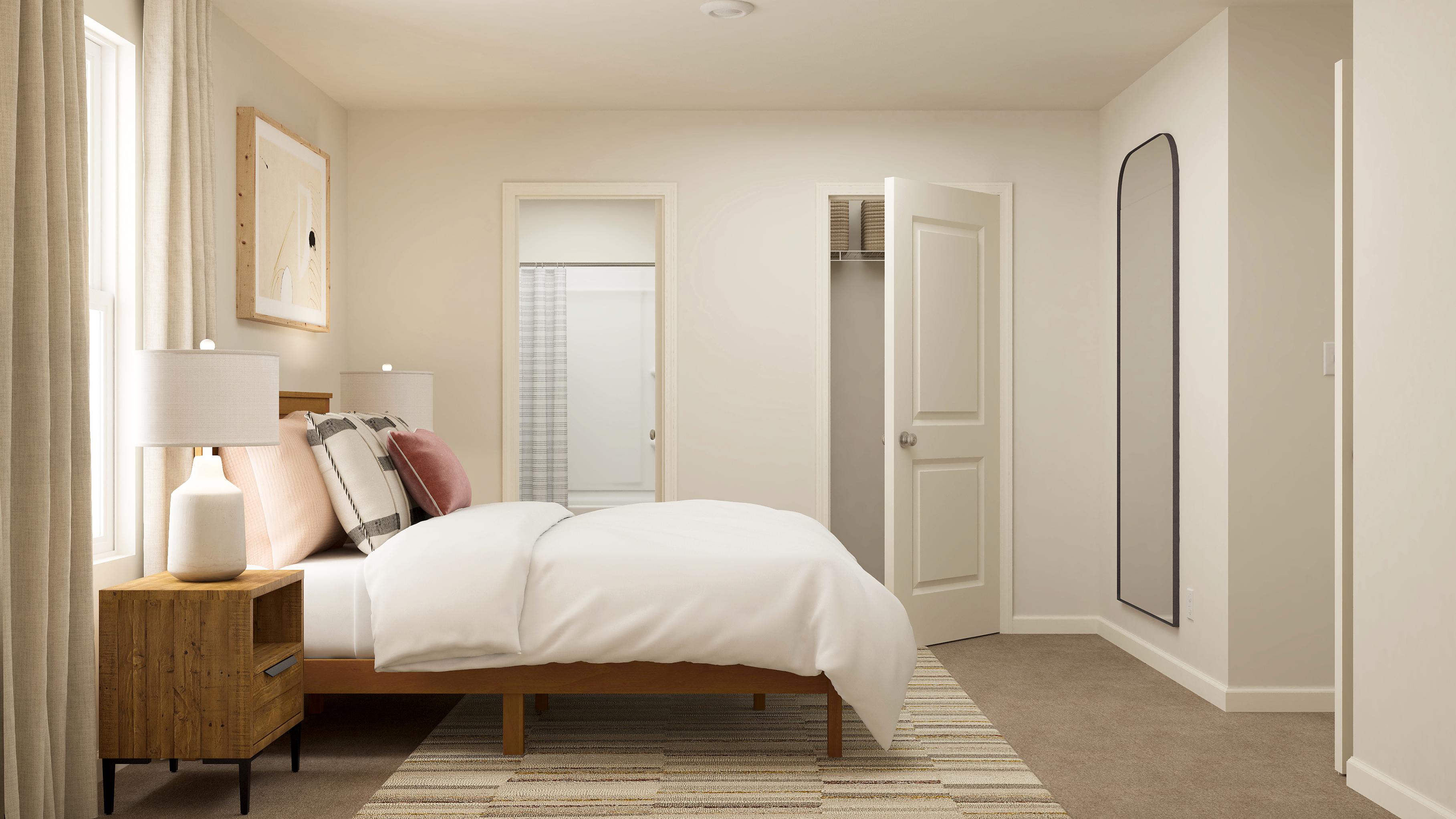 A bedroom with a bed and a lamp.