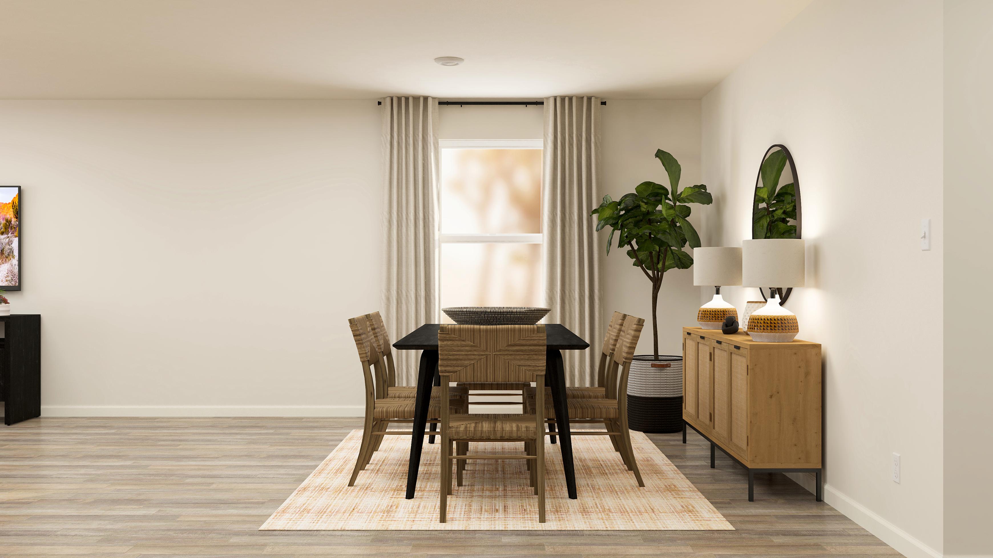 A dining room with a table and chairs.