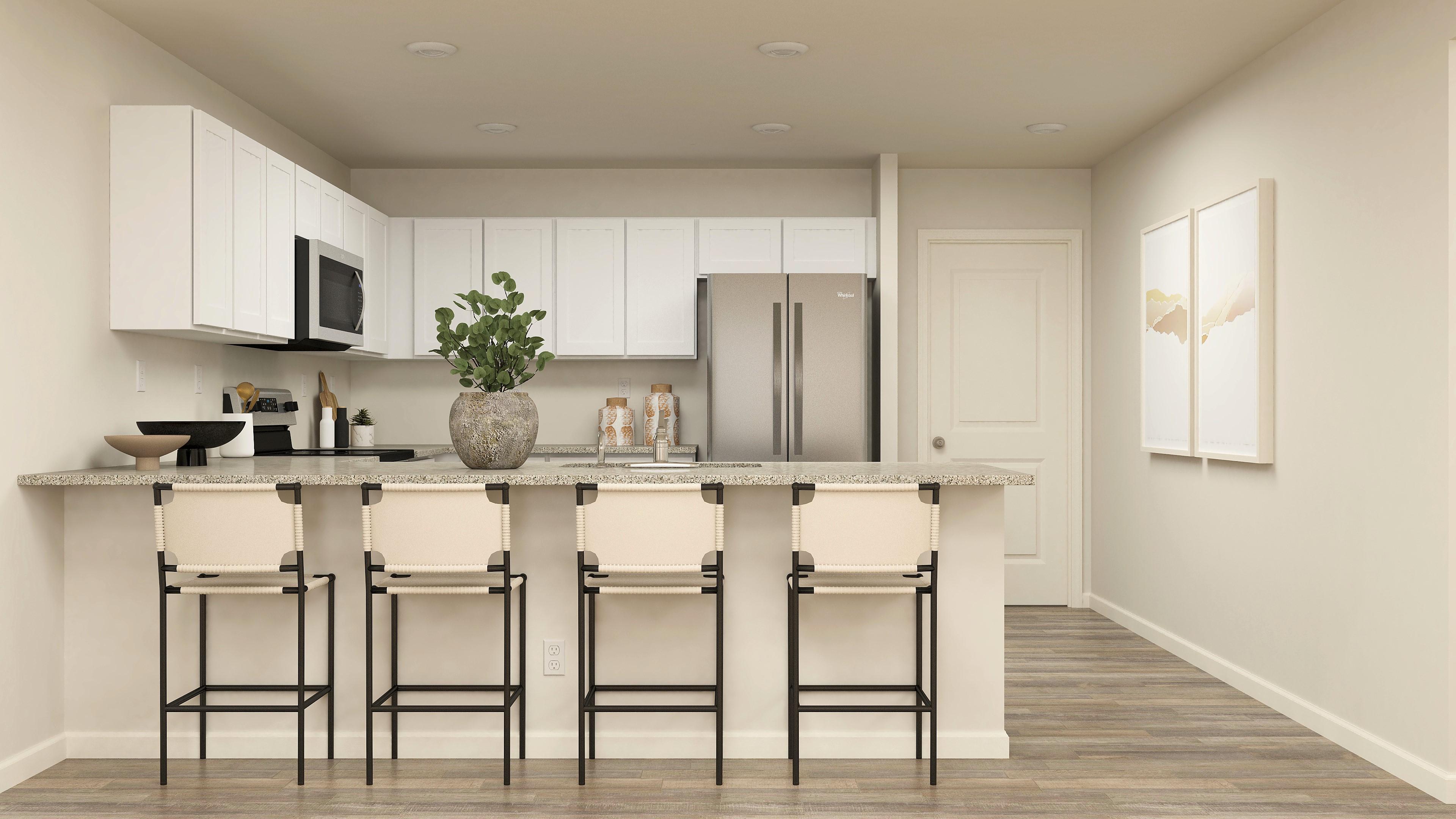 A kitchen with white cabinets.