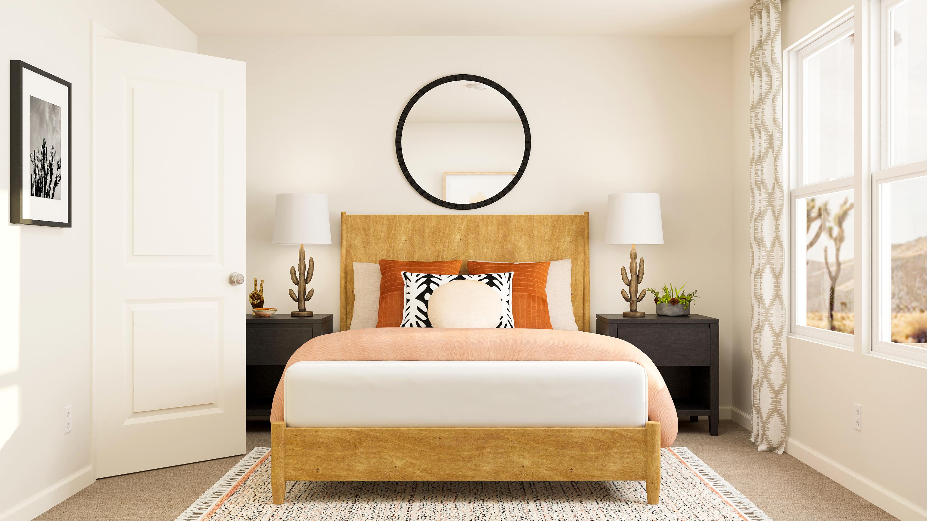 A bedroom with a bed and lamps.