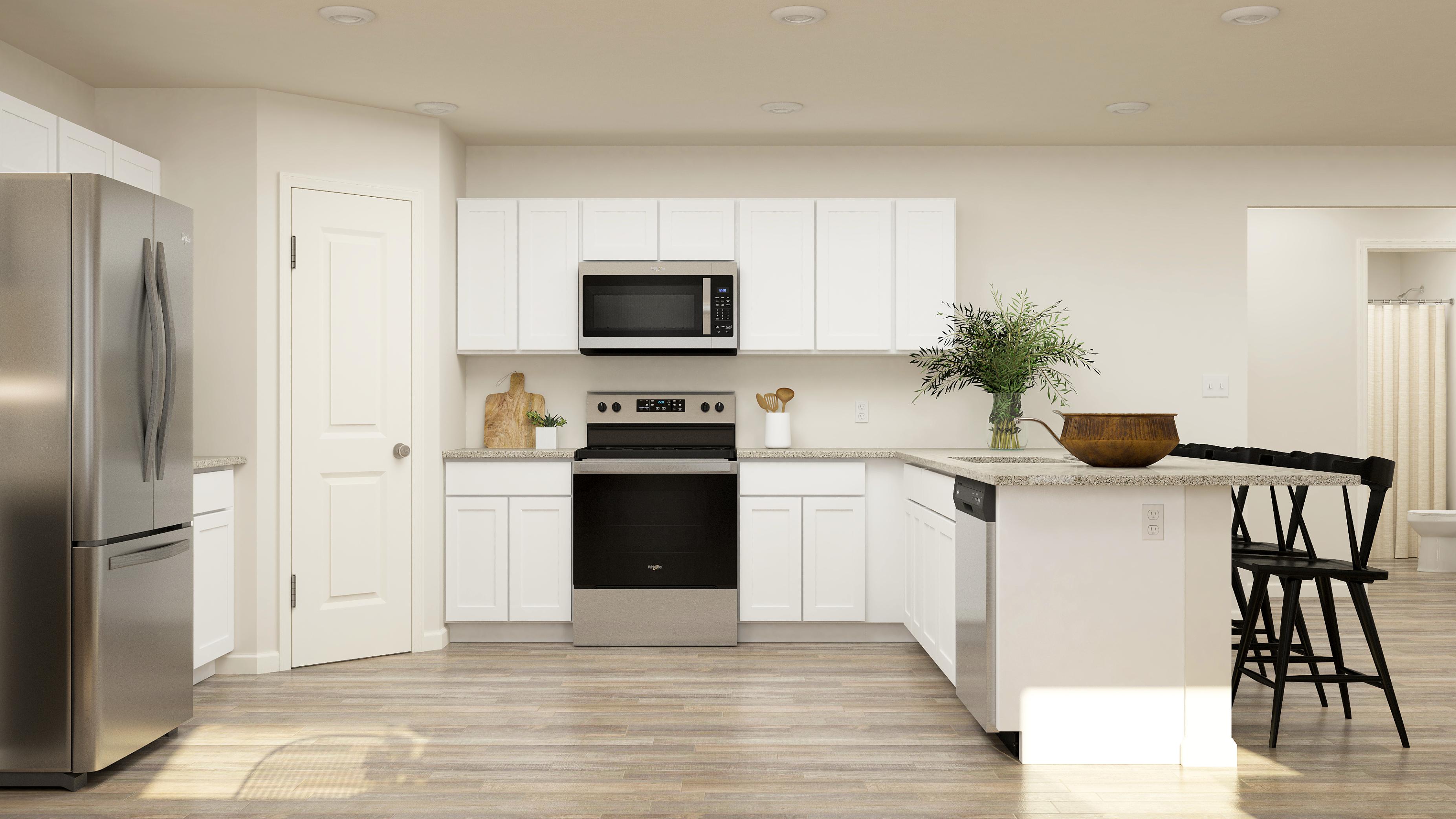 A kitchen with white cabinets.