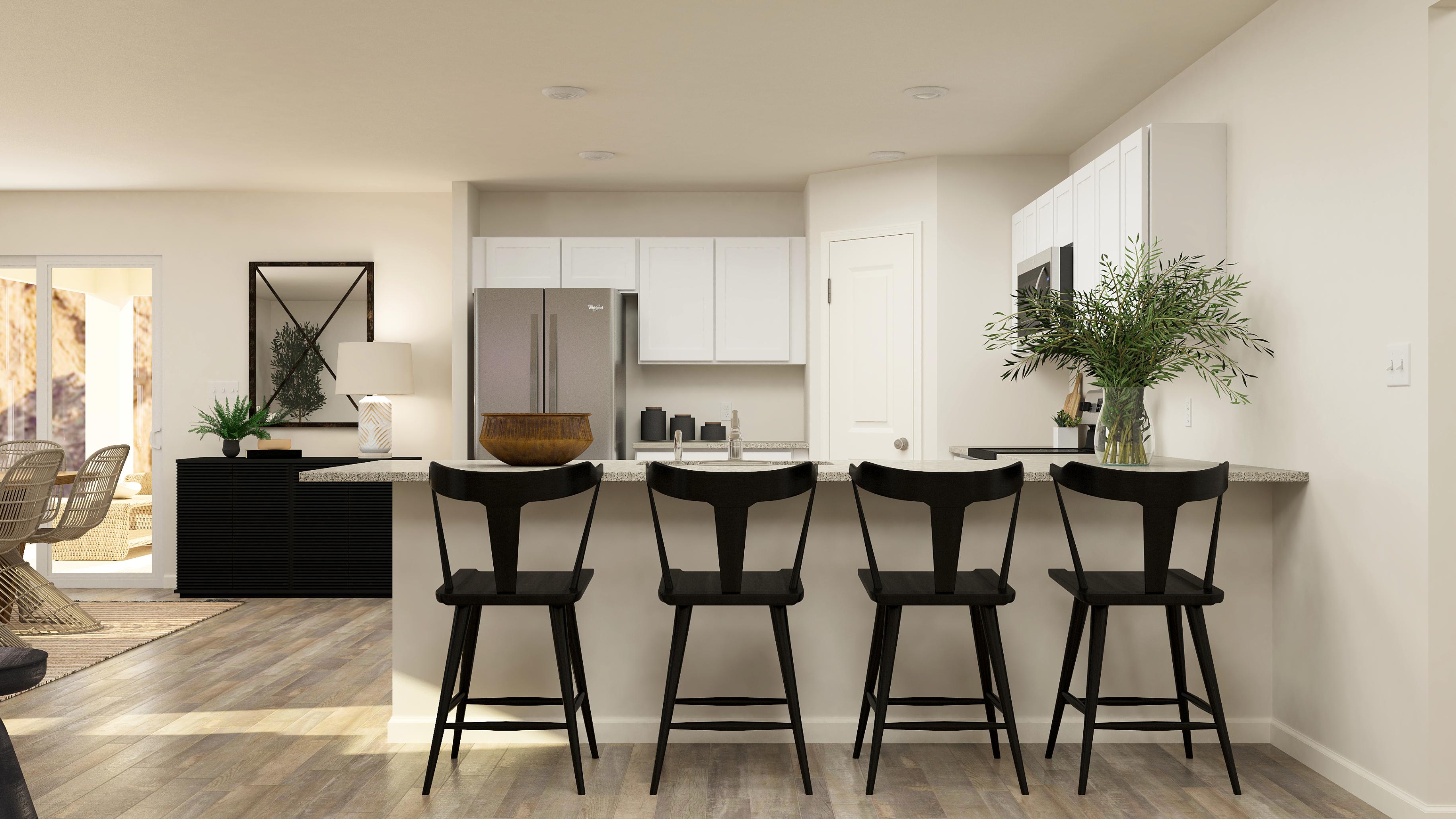 A room with a table chairs and a plant.