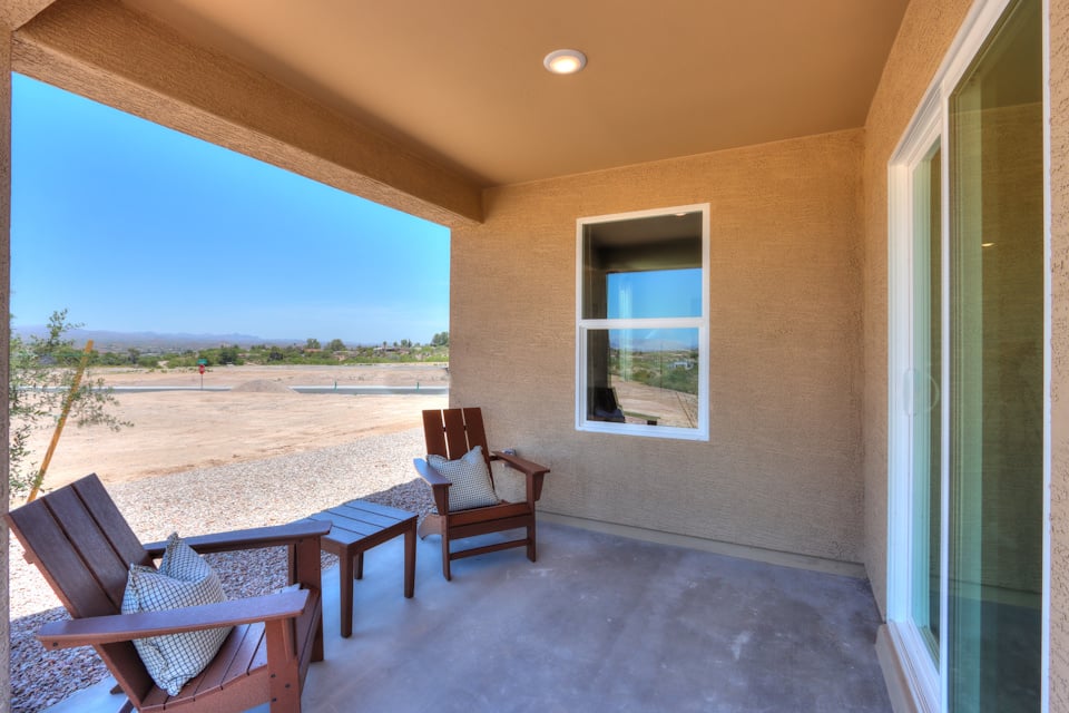 A patio with chairs and a table.