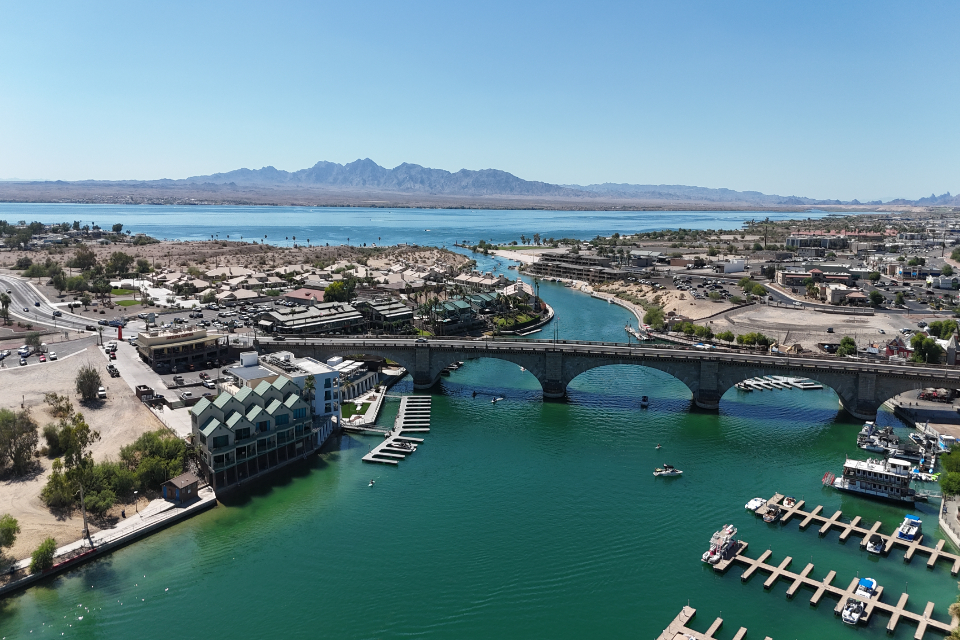 A bridge over a river with boats.