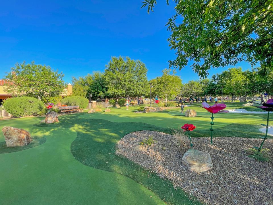 A golf course with a green field.