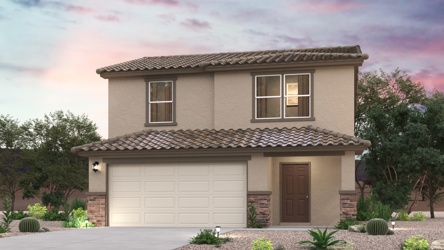 A house with a garage and trees.