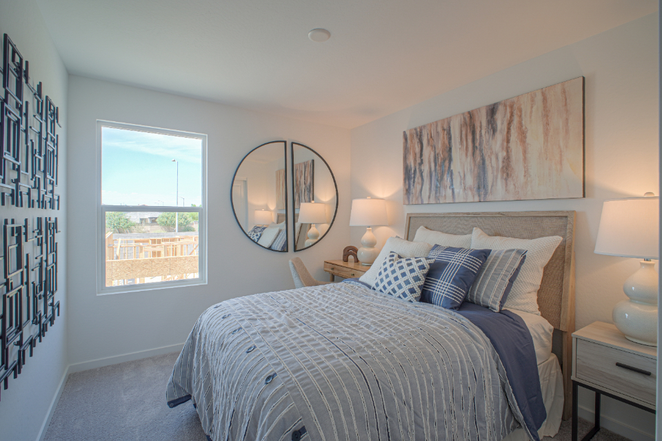 A bedroom with a large mirror.