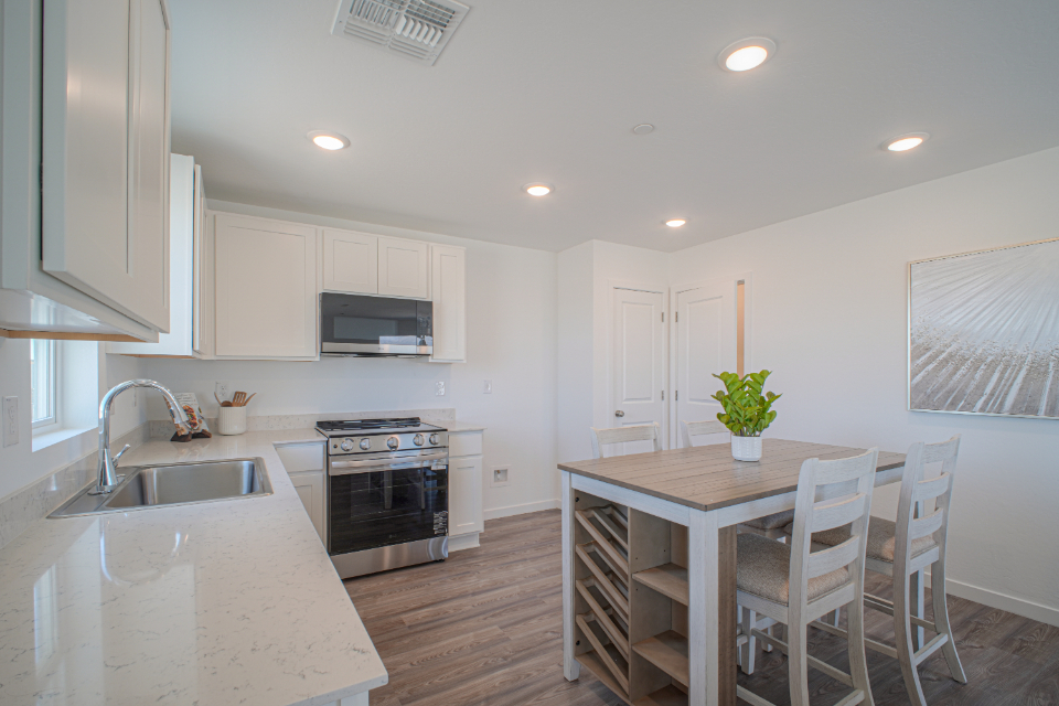 A kitchen with white cabinets.