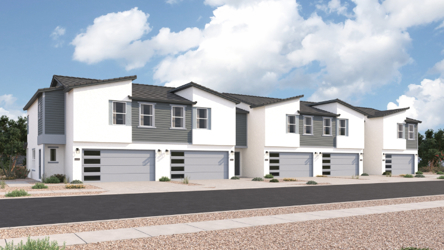 A white house with garages.