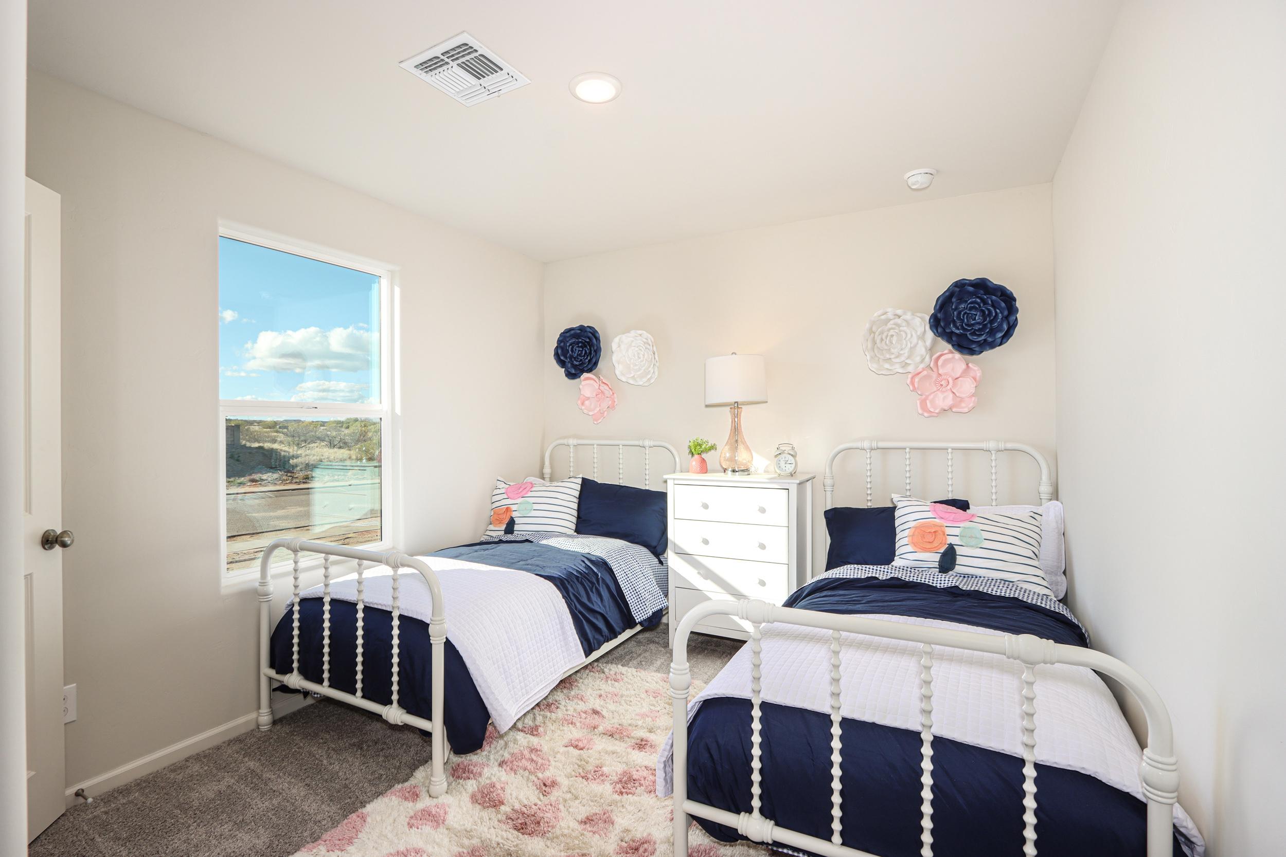 A bedroom with two beds.