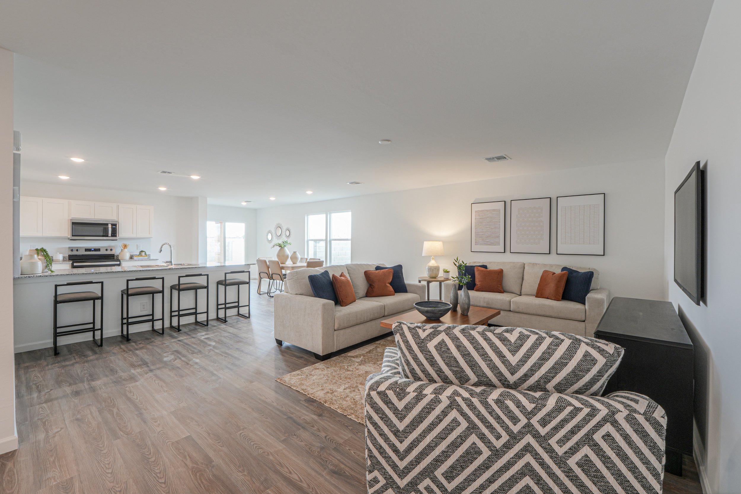 A living room with a large kitchen.