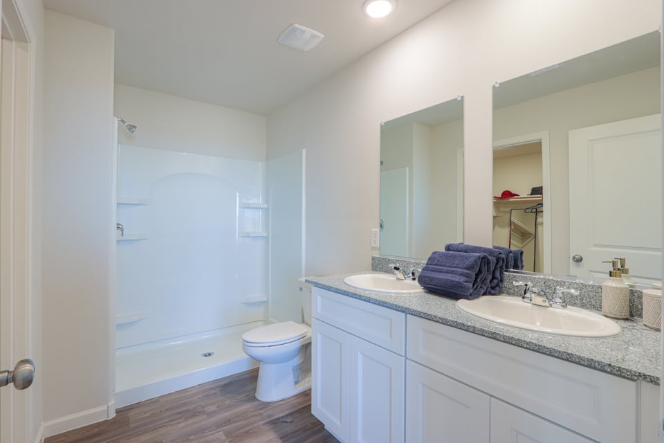 A bathroom with a tub sink and toilet.