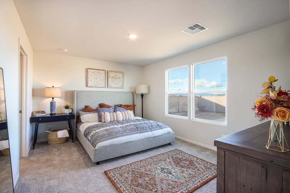 A bedroom with a large window.