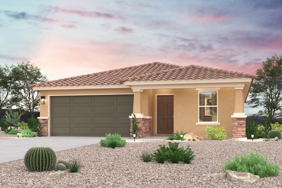 A house with a garage and bushes.