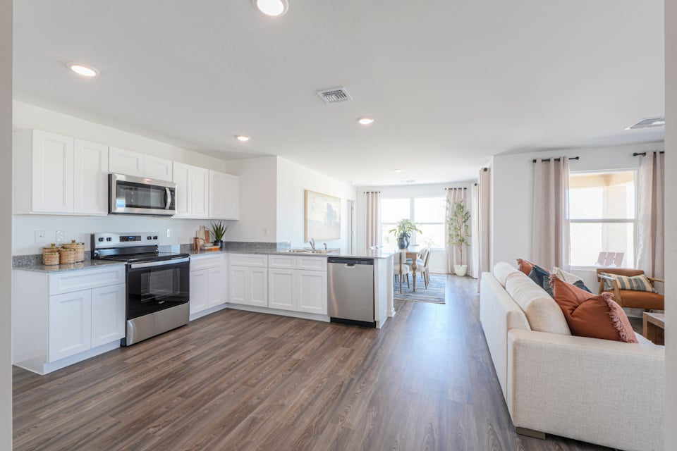A large kitchen with a wood floor.