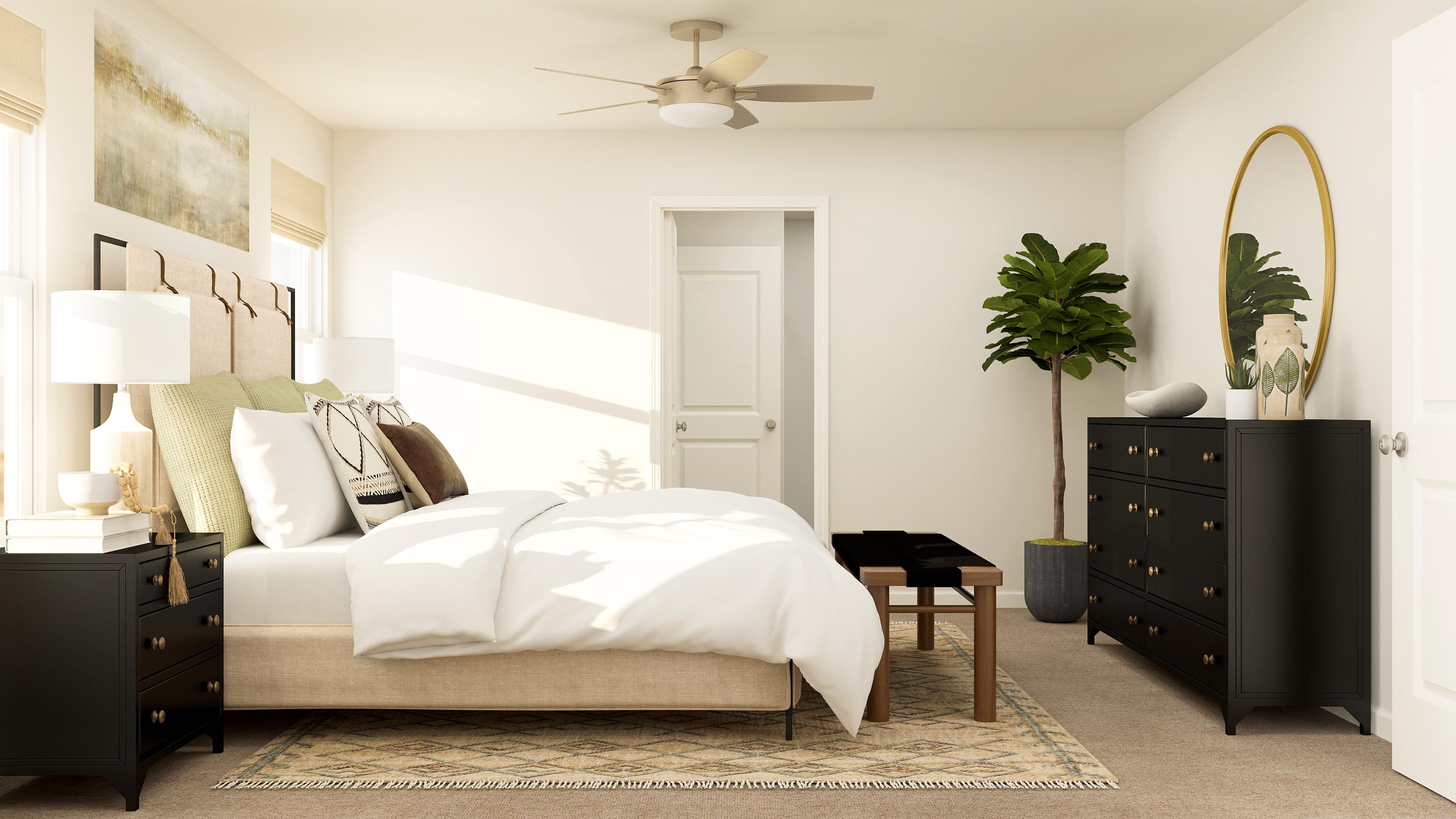 A bedroom with a bed and a plant.