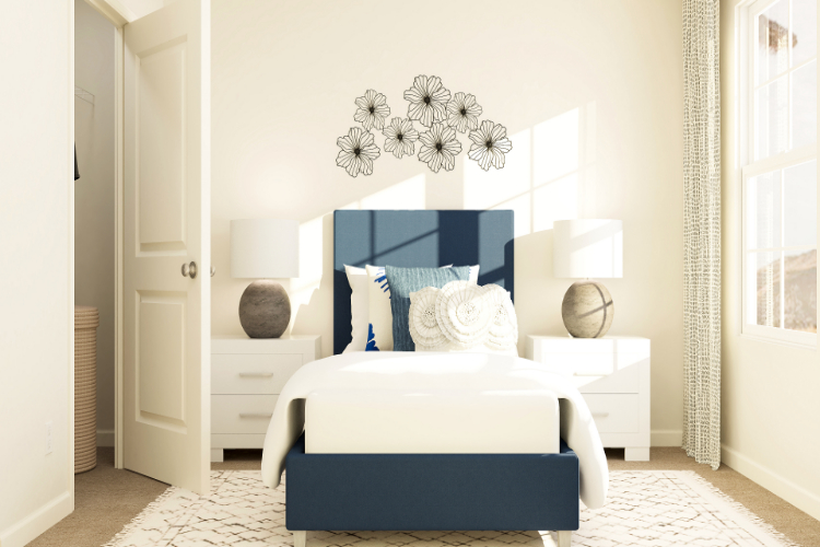 A bedroom with a white bed and a white wallpaper.