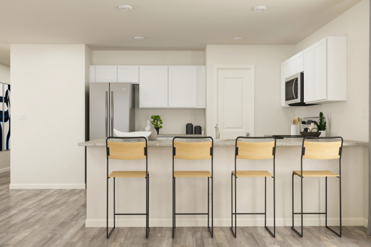 A kitchen with white cabinets.