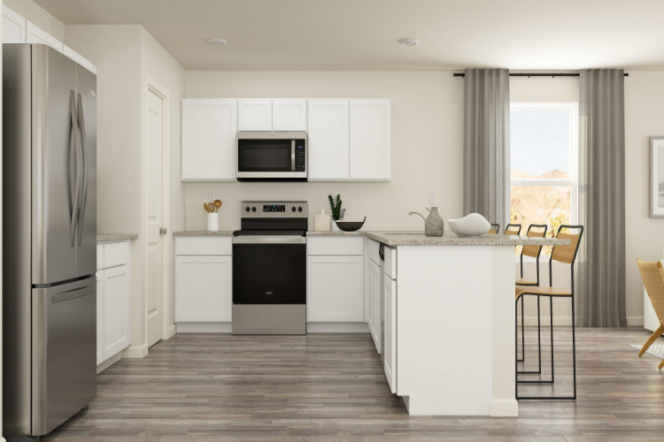 A kitchen with white cabinets.