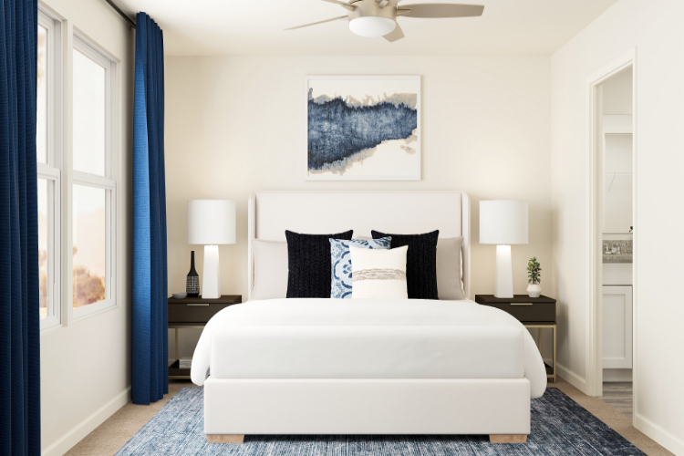 A bedroom with a bed and lamps.