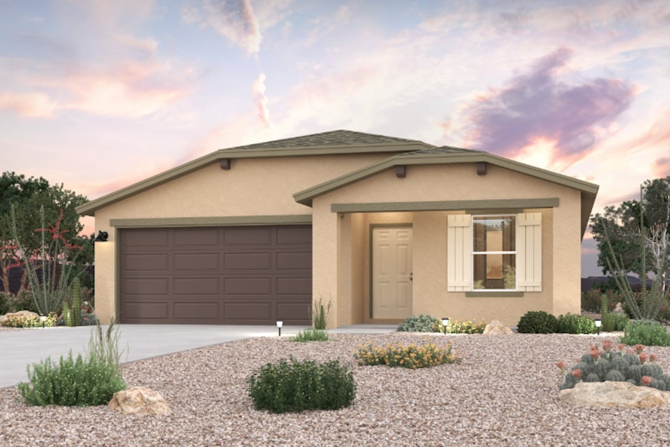 A house with a garage and bushes.