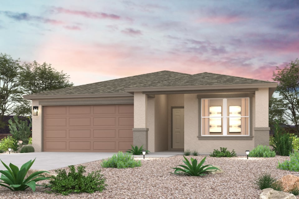 A house with a garage and a gravel driveway.