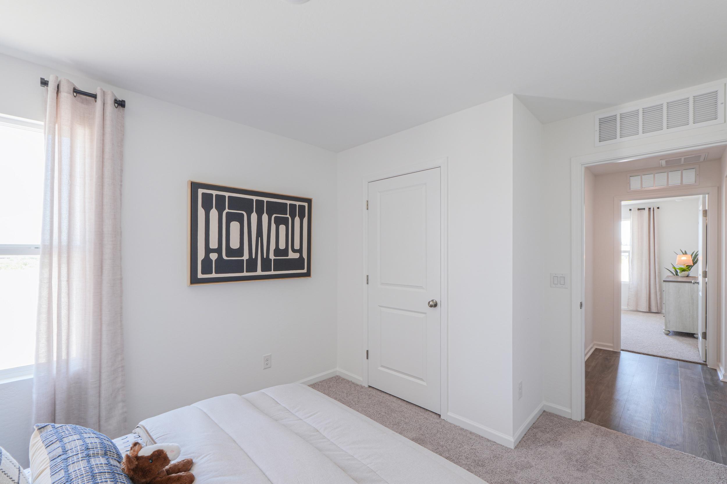 A bedroom with a bed and a window.
