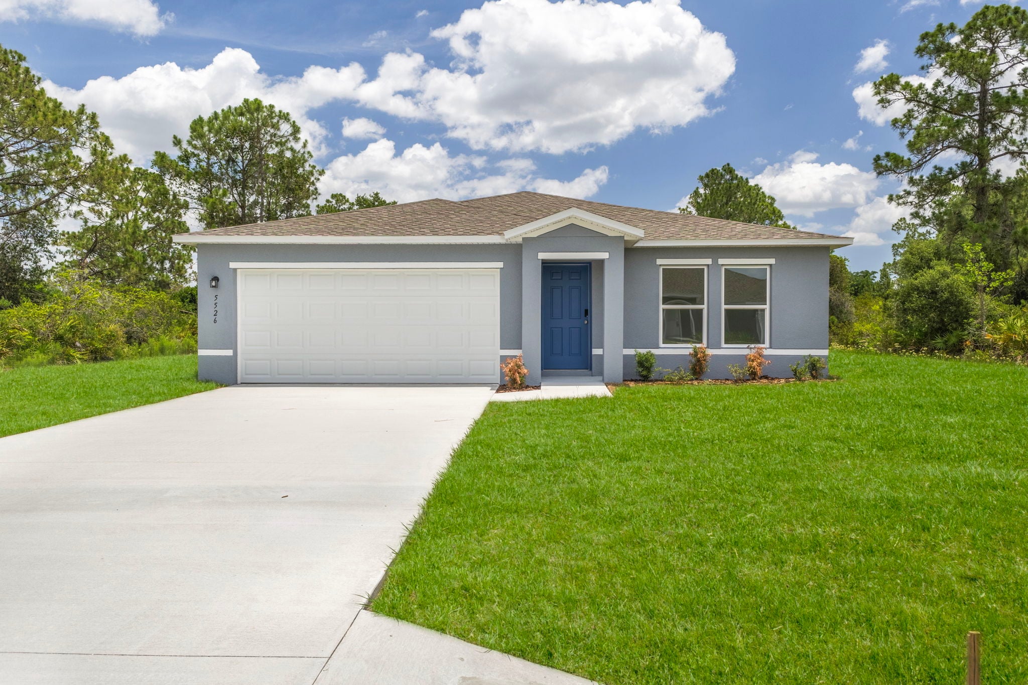 A house with a garage and grass.