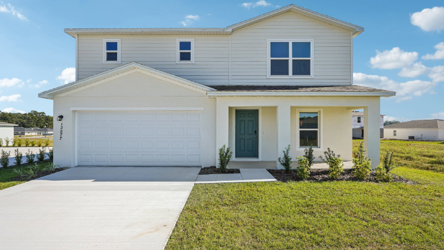 A white house with a garage.