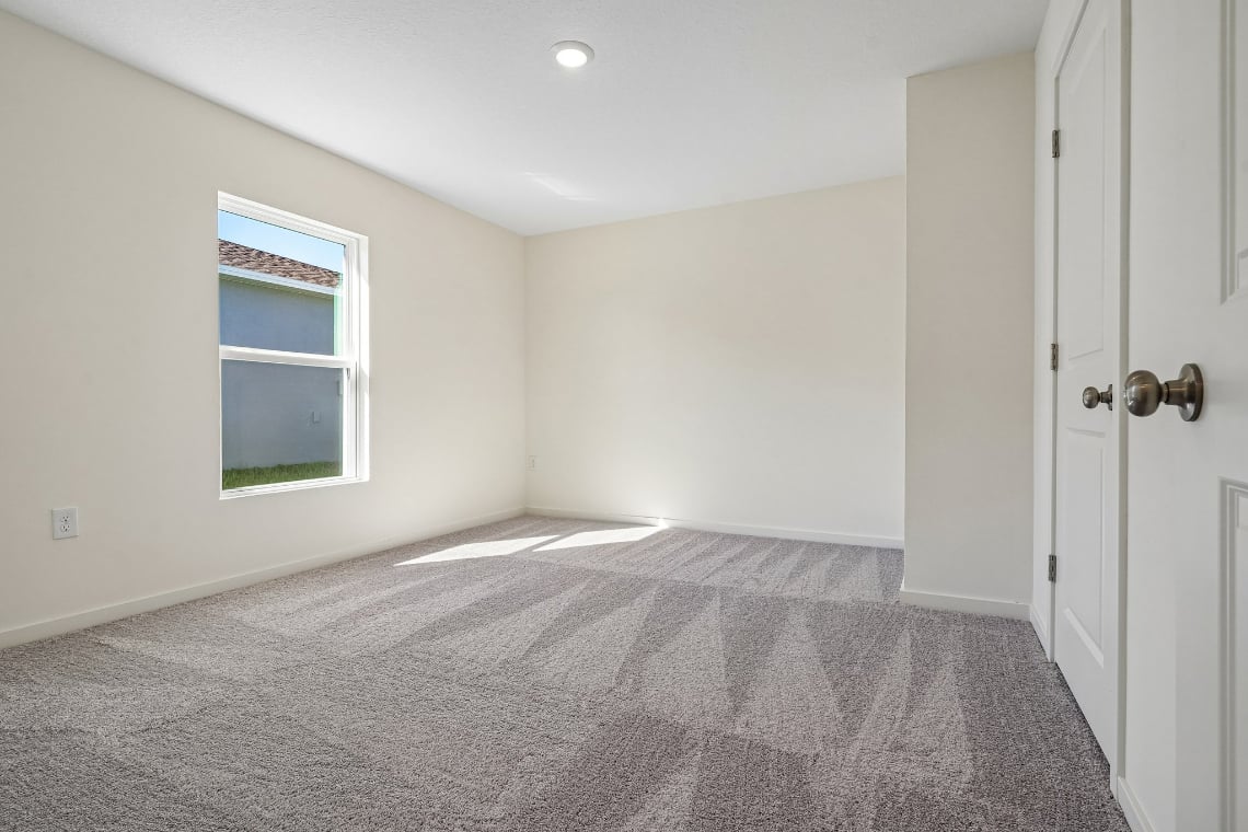 A room with a bed and a window.